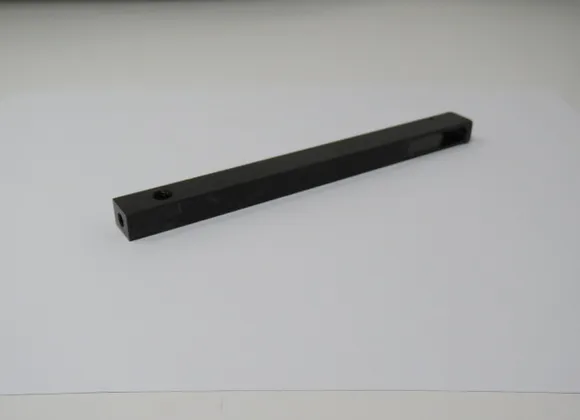 A black bar with two holes on top of it.