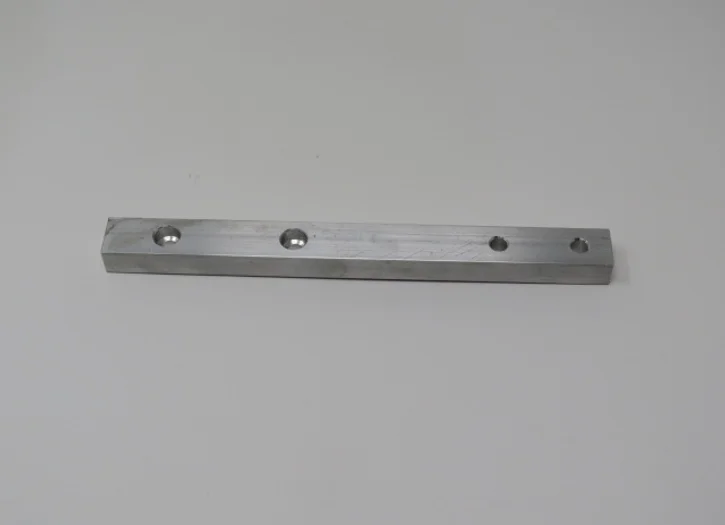 A metal bar with holes for the bottom of it.