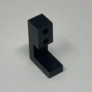 A black plastic block with two holes.