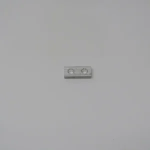 A white piece of plastic sitting on top of a wall.