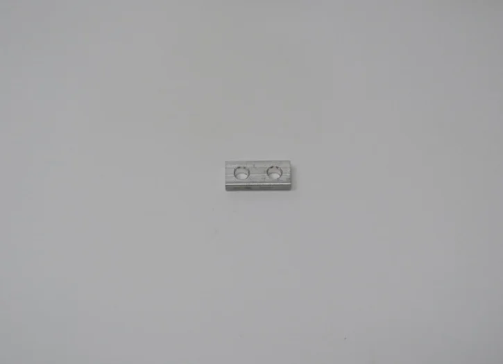 A white piece of plastic sitting on top of a wall.