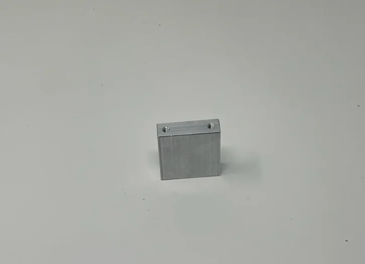 A metal box sitting on top of a white surface.