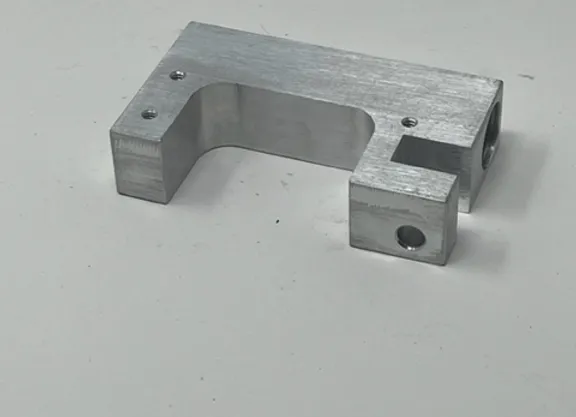 A metal part that is sitting on the ground.