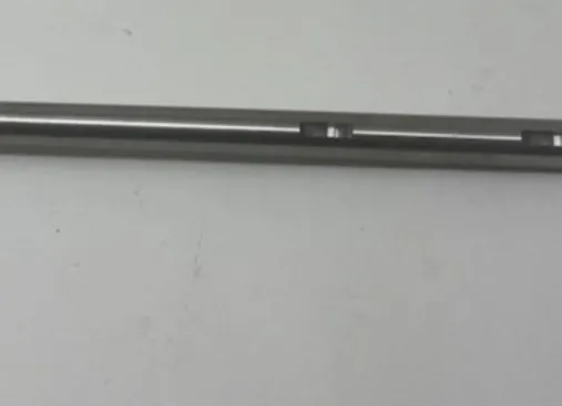 A metal rod with two holes in it.