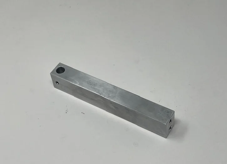 A metal bar with two holes in it.