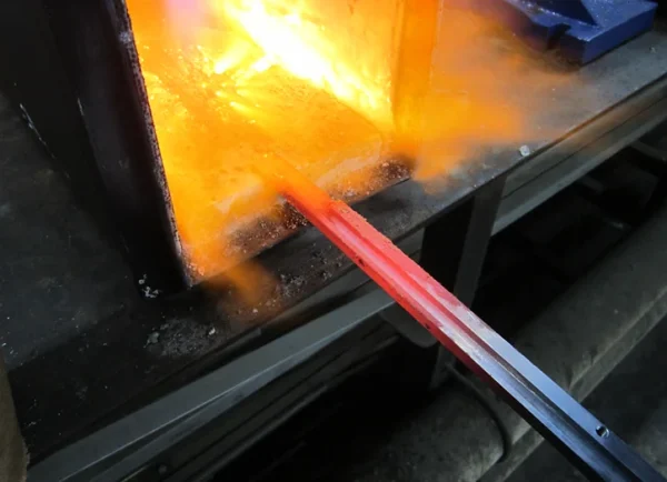 A glass blowing machine is being used to produce the flames.