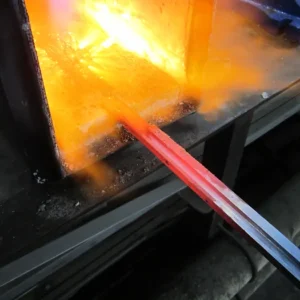 A glass blowing machine is being used to produce the colors of the flag.