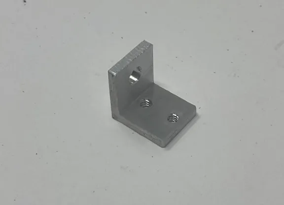 A metal angle with two holes for mounting.