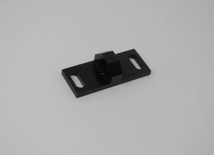 A black piece of plastic sitting on top of a table.