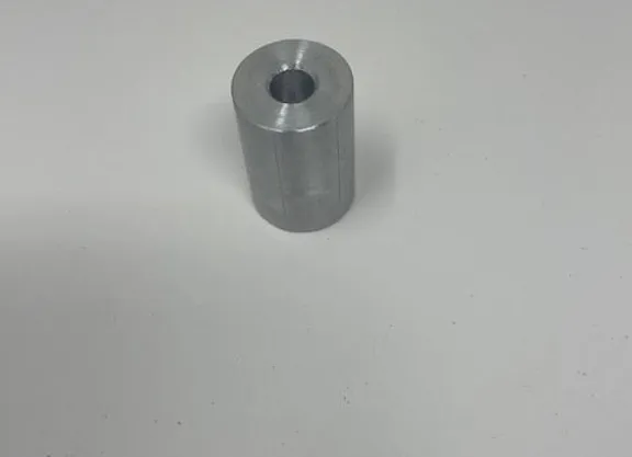 A metal cylinder sitting on top of a table.