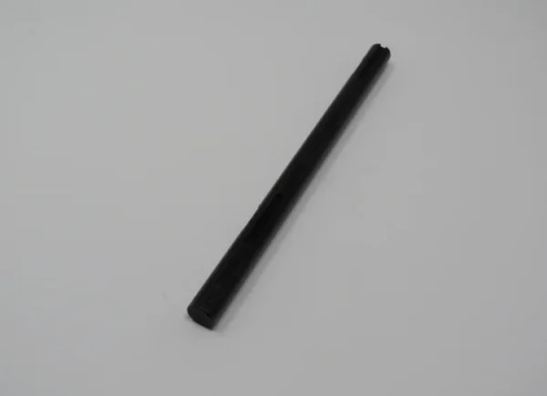 A black stick is sitting on top of the floor.