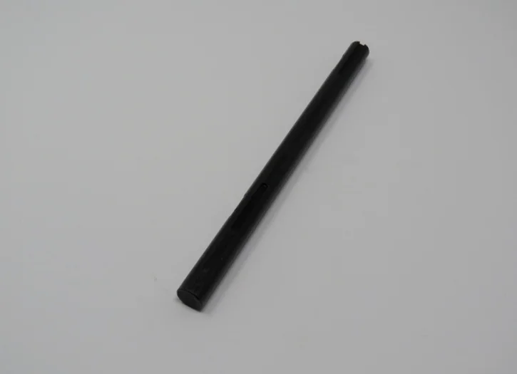 A black stick is sitting on top of the floor.