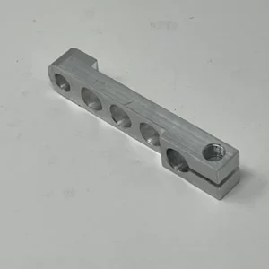 A silver bar with holes for the handle.