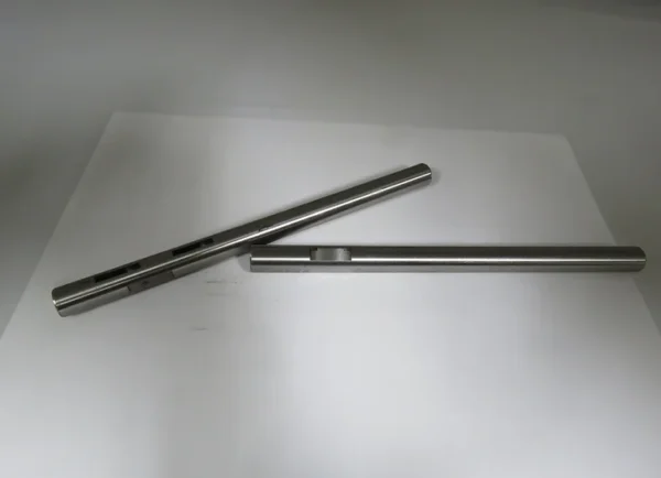 A pair of metal rods sitting on top of a table.