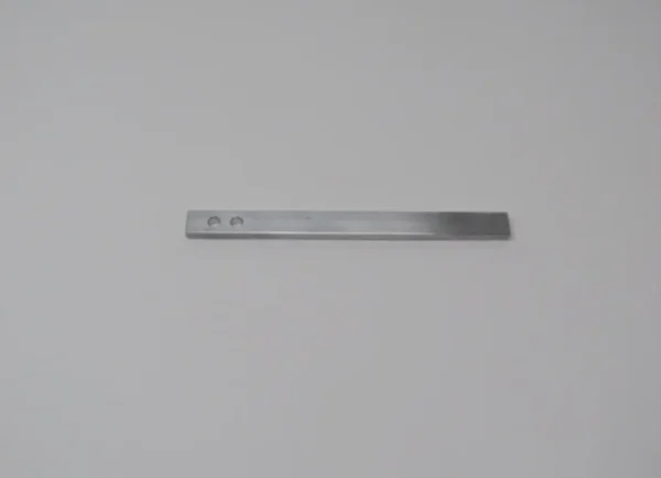 A metal ruler is shown on the wall.