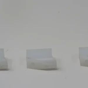 A group of three white chairs in the snow.