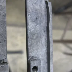 A close up of the side of a metal structure.