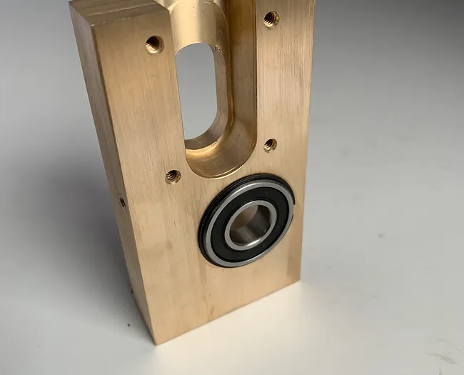 A wooden block with a bearing on the side.