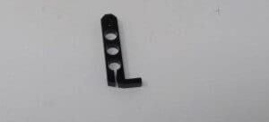 A black plastic object is sitting on top of the floor.